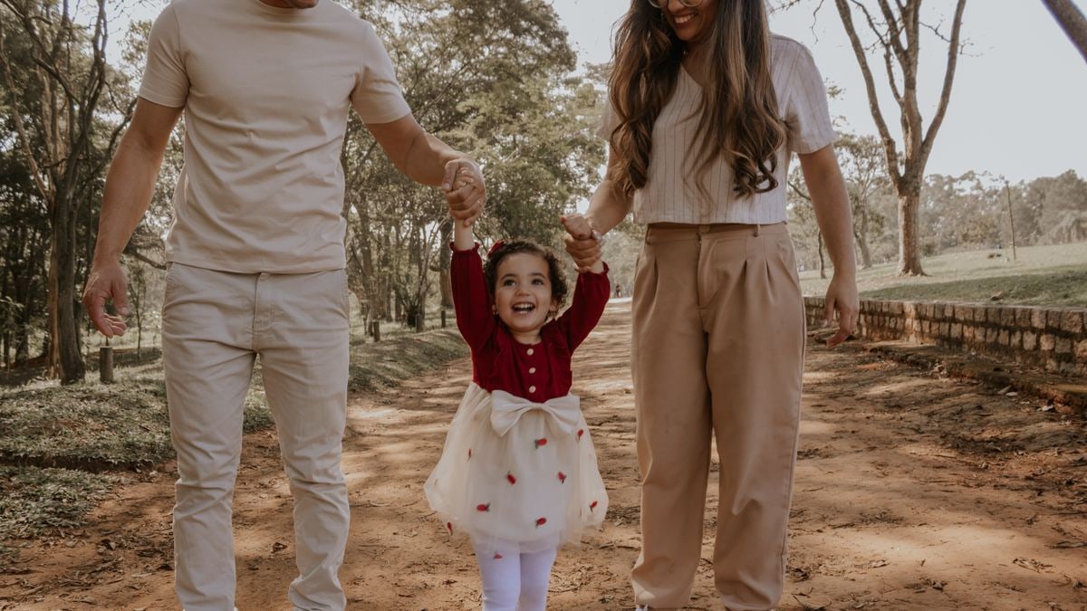 Happy family moment strolling through a park in São Paulo, capturing joy and connection.